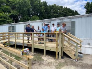 Group of people standing on a wood deck